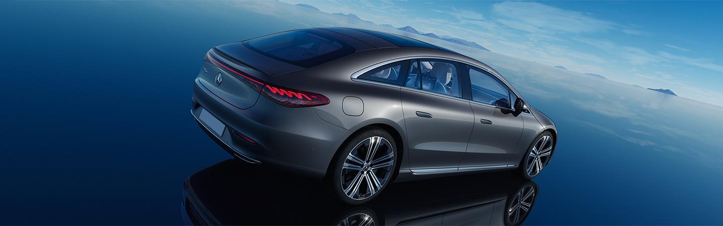 Back side view of a Front view of a 2022 Mercedes-Benz EQS-Class light up blue parked on glass