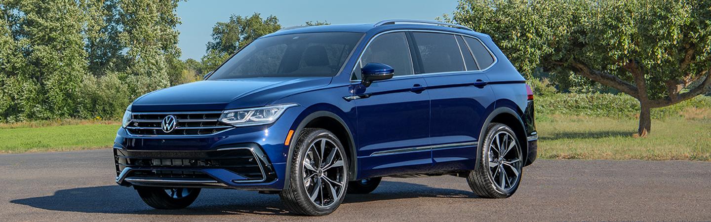 Blue 2022 Volkswagen Tiguan parked by some trees
