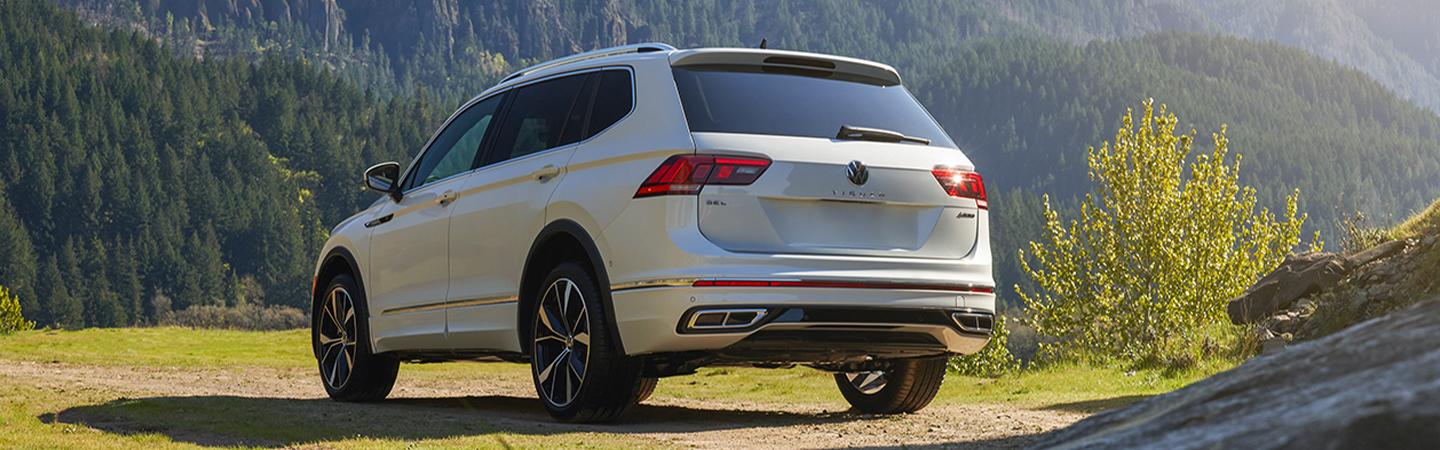 back view of a 2022 Volkswagen Tiguan parked by the woods