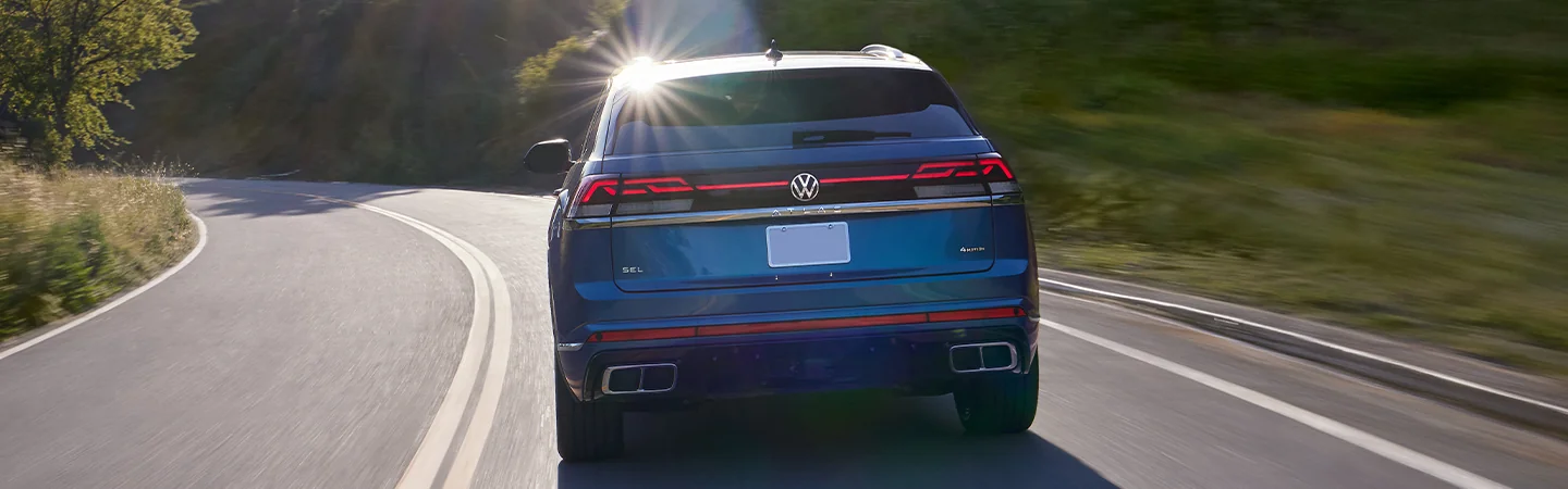 rear view of a 2025 Volkswagen Atlas Cross Sport SE on road in motion