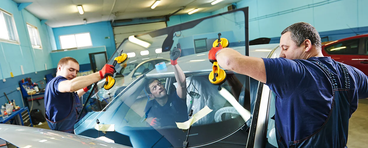 Service techs installing a new windshield
