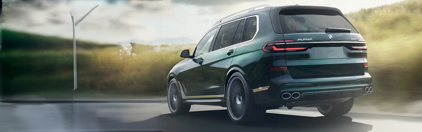 2024 Range Rover vs 2024 BMW X7 back side in green 