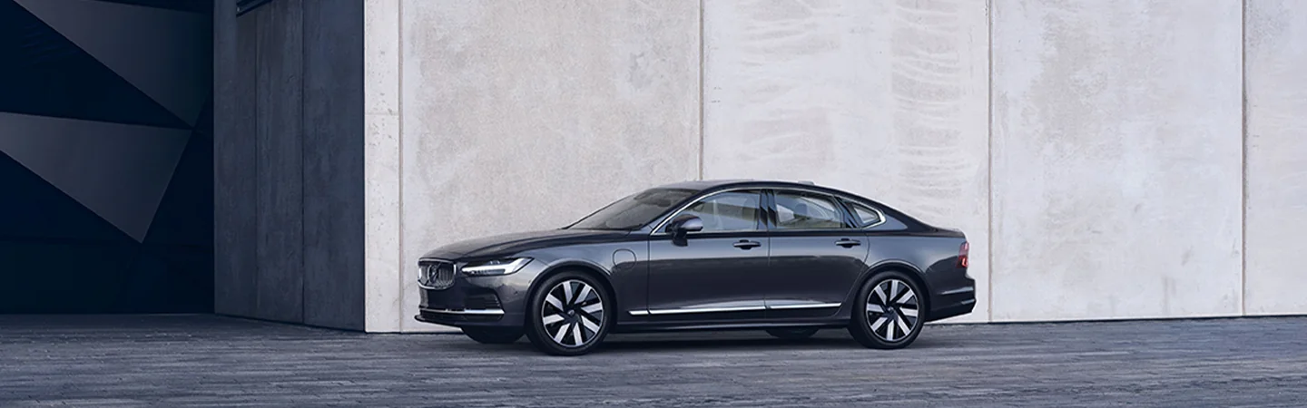 black 2025 Volvo S90 Plug-in Hybrid parked with wall