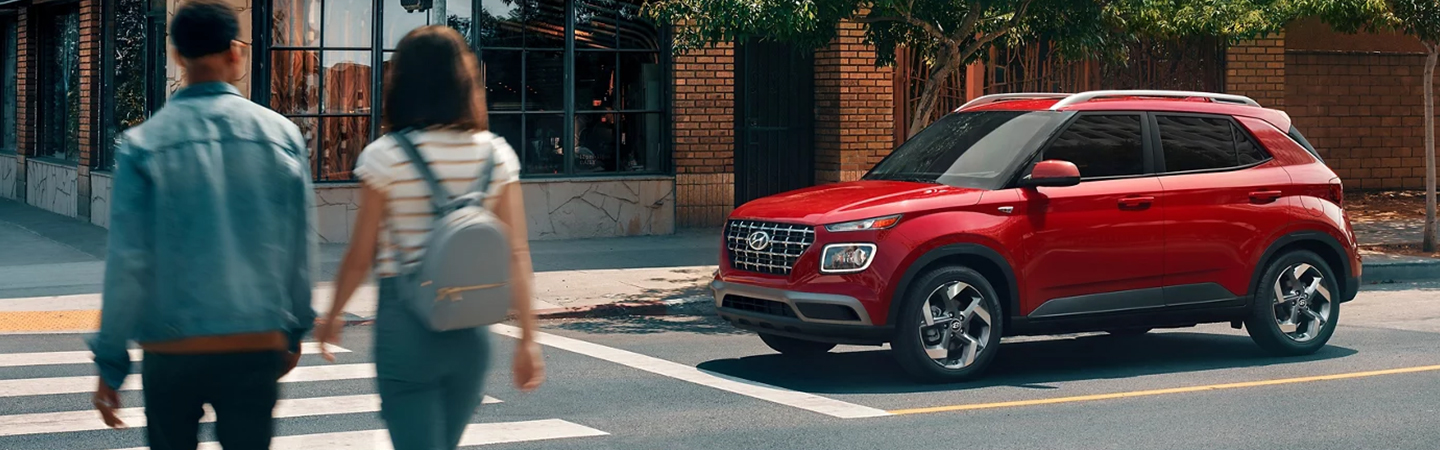 Comparison: 2024 Kia Soul vs. Hyundai Venue red color side view