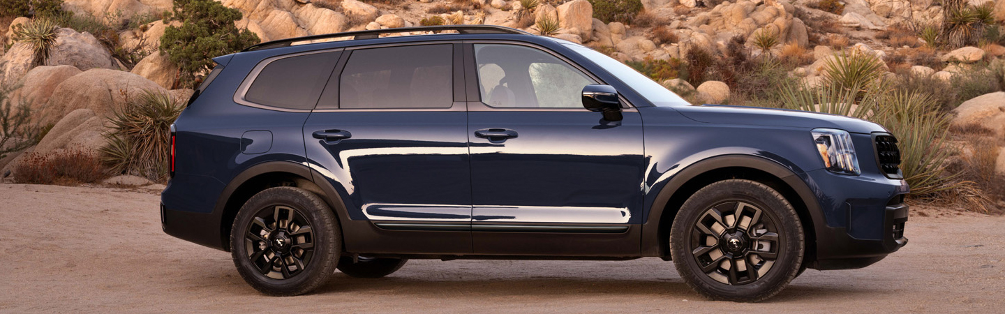 2024 Kia Telluride vs Ford Explorer side front in blue