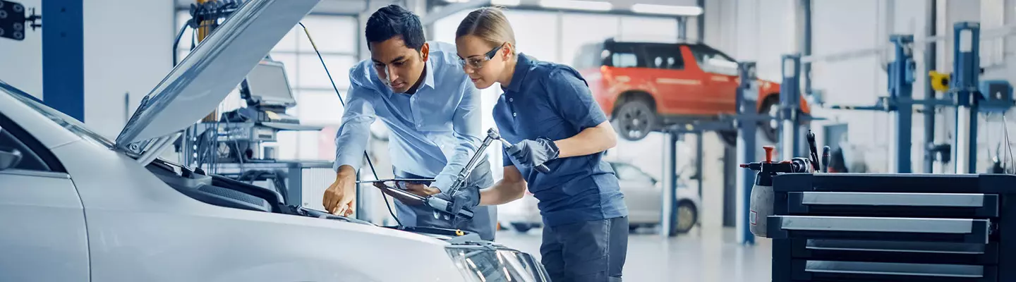tech and mechanic working on a vehicle