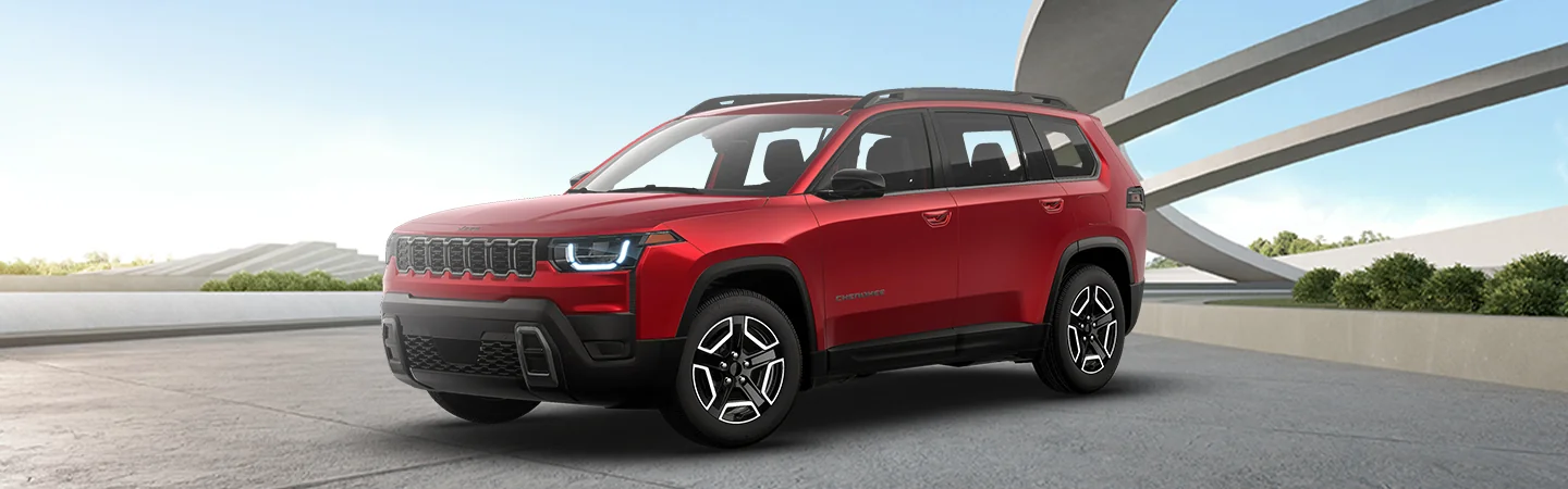 Side view of a parked red 2026 Jeep Cherokee out side