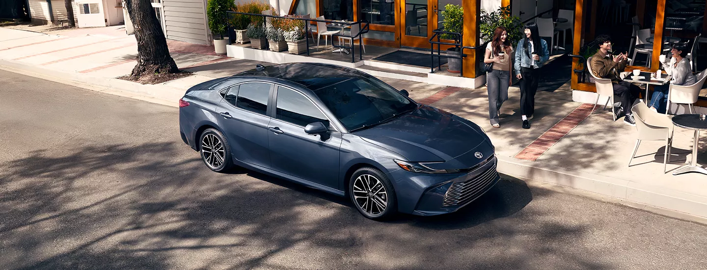 2026 Toyota Camry parked outside a cafe in the city
