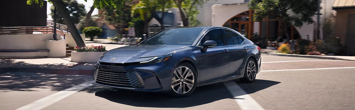 2026 Toyota Camry driving through the city in the daytime
