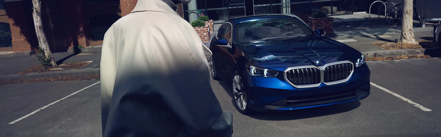 over the shoulder look at blue BMW at night