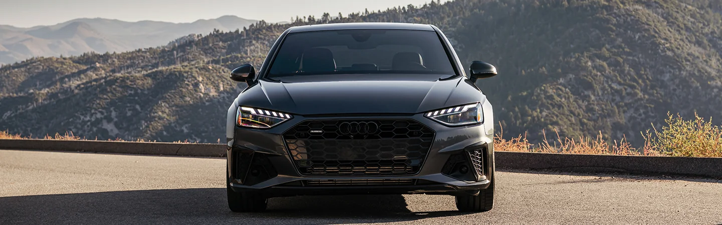 Front view of a parked gray 2025 Audi A4 at a mountain overlook