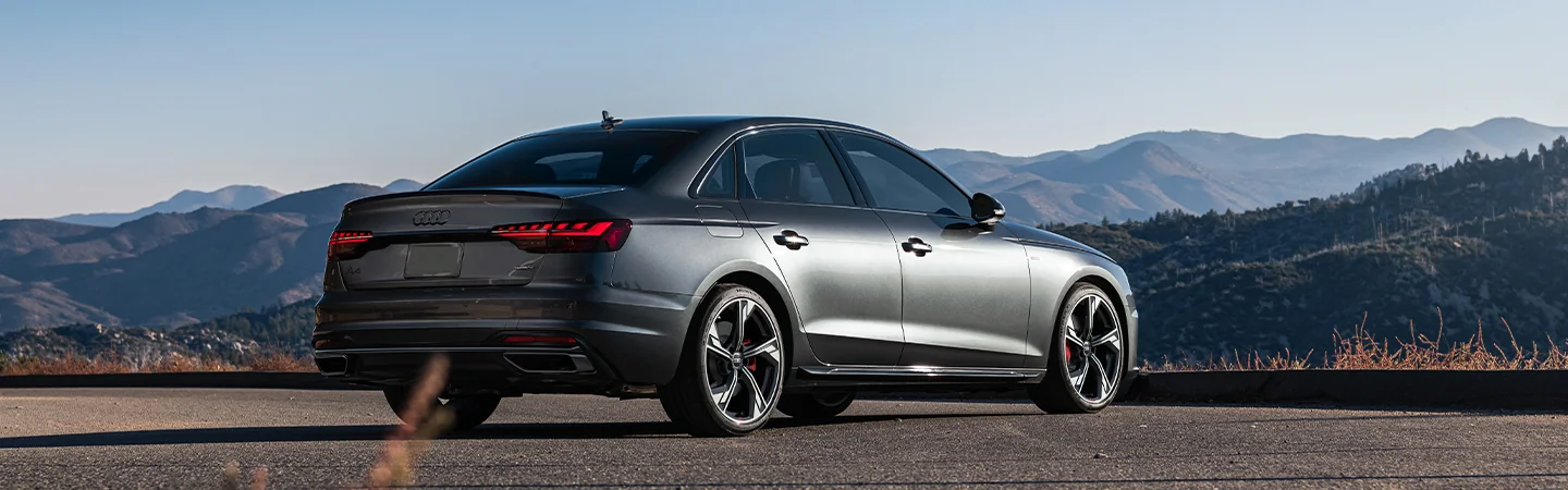 Back side view of a parked gray 2025 Audi A4 at a mountain overlook