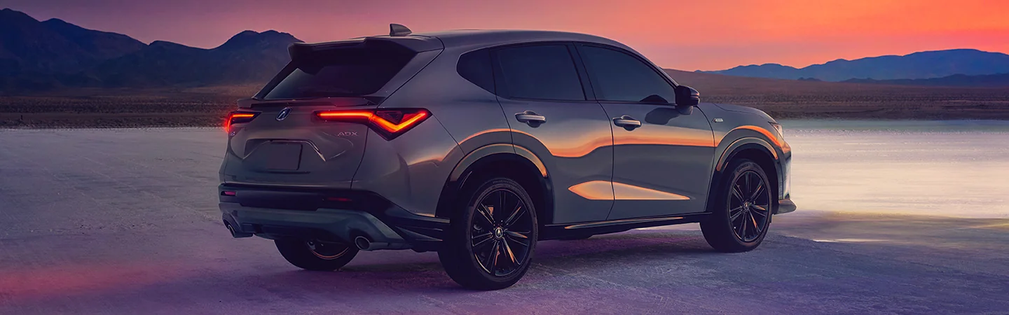 Back side view of a parked gray 2025 Acura ADX