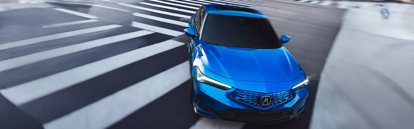 Top view of a blue 2026 Acura Integra driving on a highway