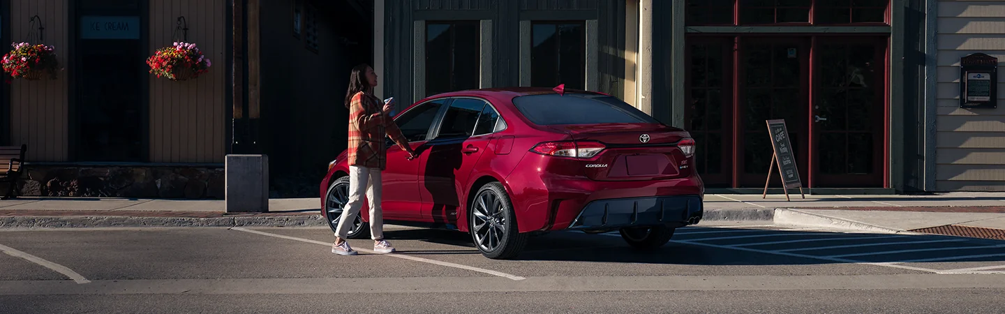 a person getting into a 2026 Toyota Corolla