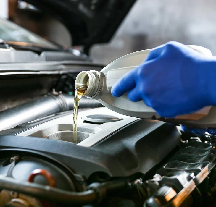 mechanic in the shop room running a diagnosis of a vehicle on the computer