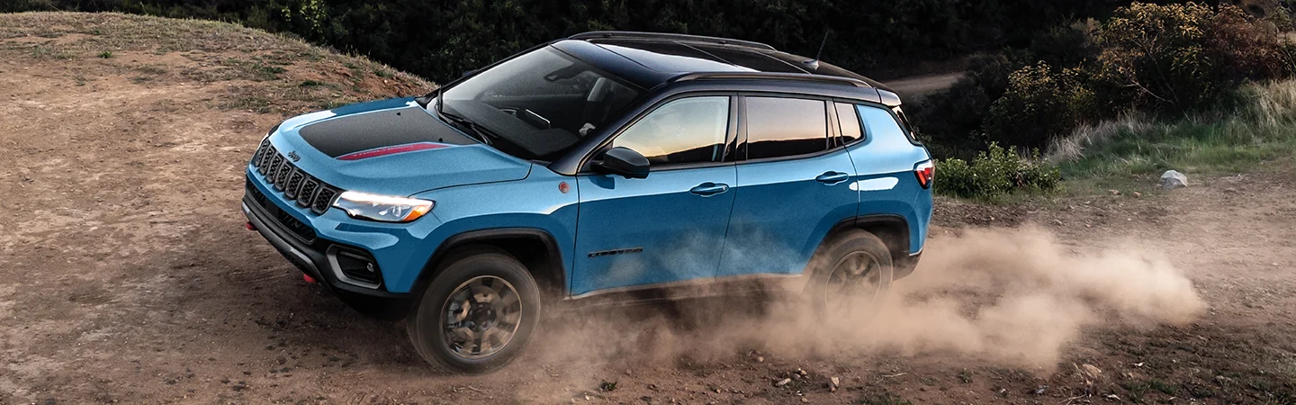a blue 2026 Jeep Compass Limited offroad
