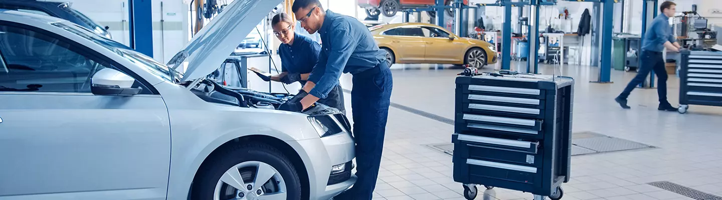 Mechanic working under the hood of a vehicle