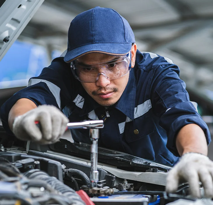 mechanic in the shop room doing engine work