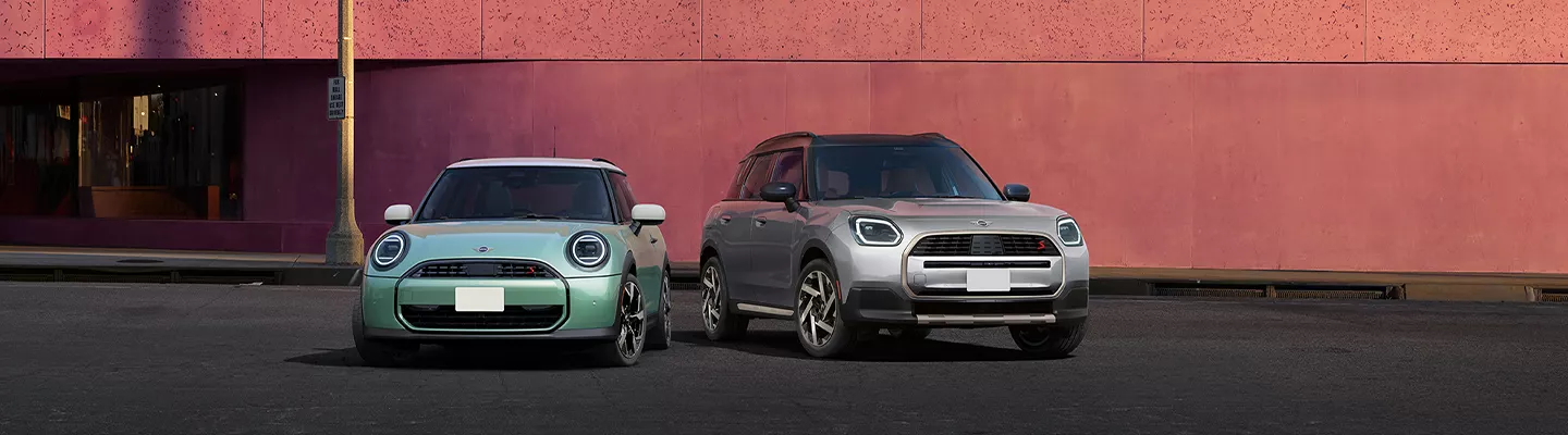 Front view of two MINI Countryman vehicles parked in a city parking lot