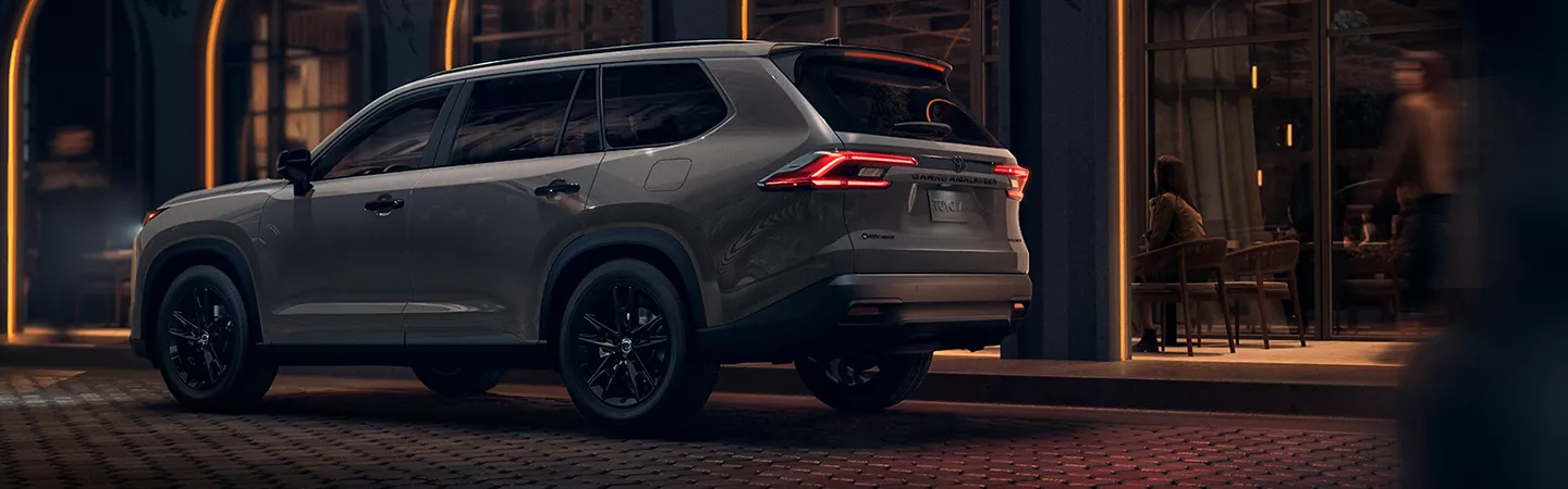 2026 Toyota Grand Highlander Hybrid parked next to a residence at night