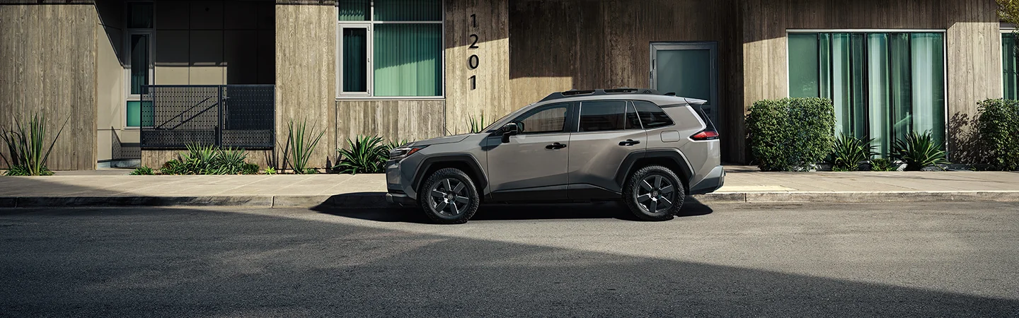 a red 2026 Toyota RAV4 on a curve