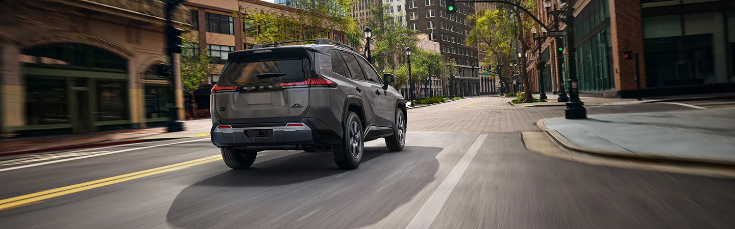 rear view of a 2026 Toyota RAV4 on country road