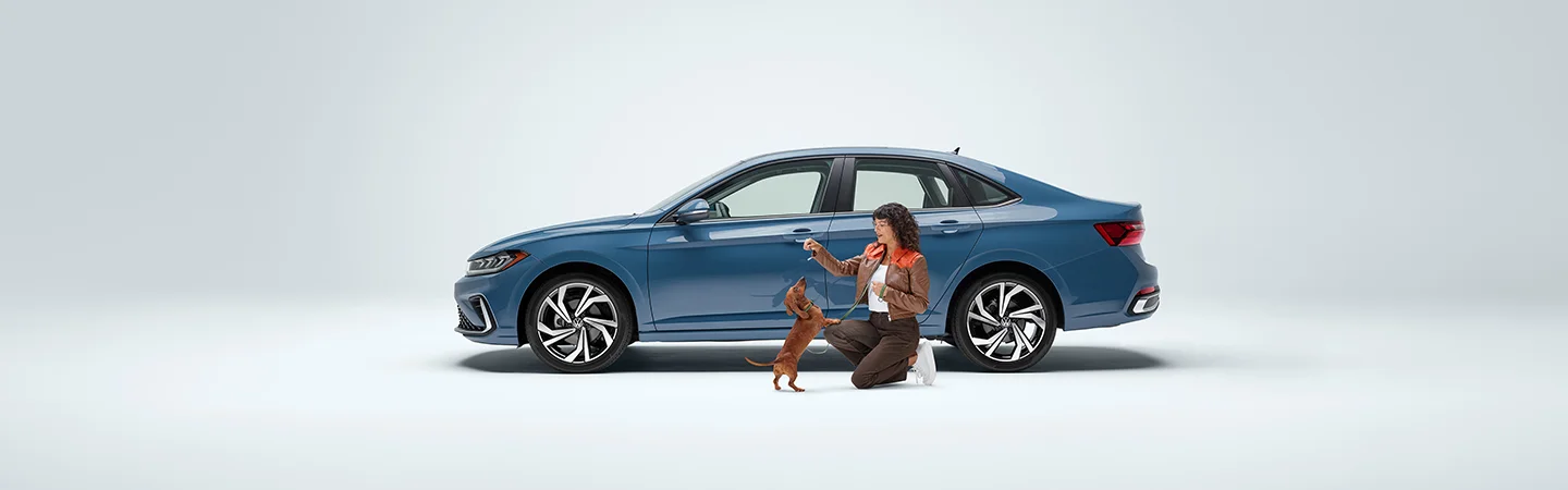 a Volkswagen Jetta with person and a dog