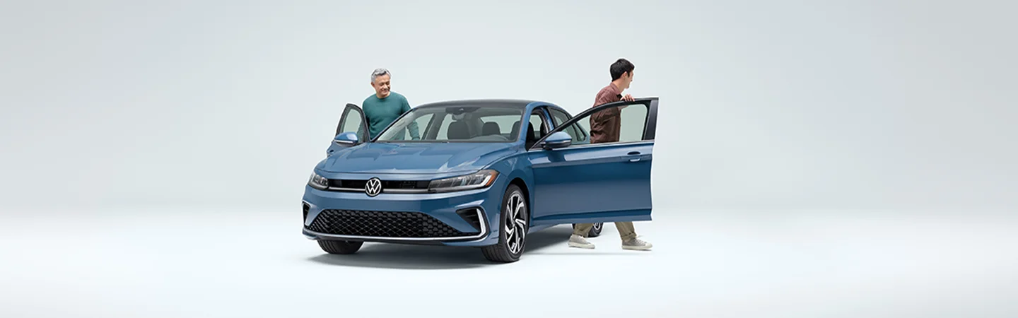 Volkswagen Jetta with two people boarding the car