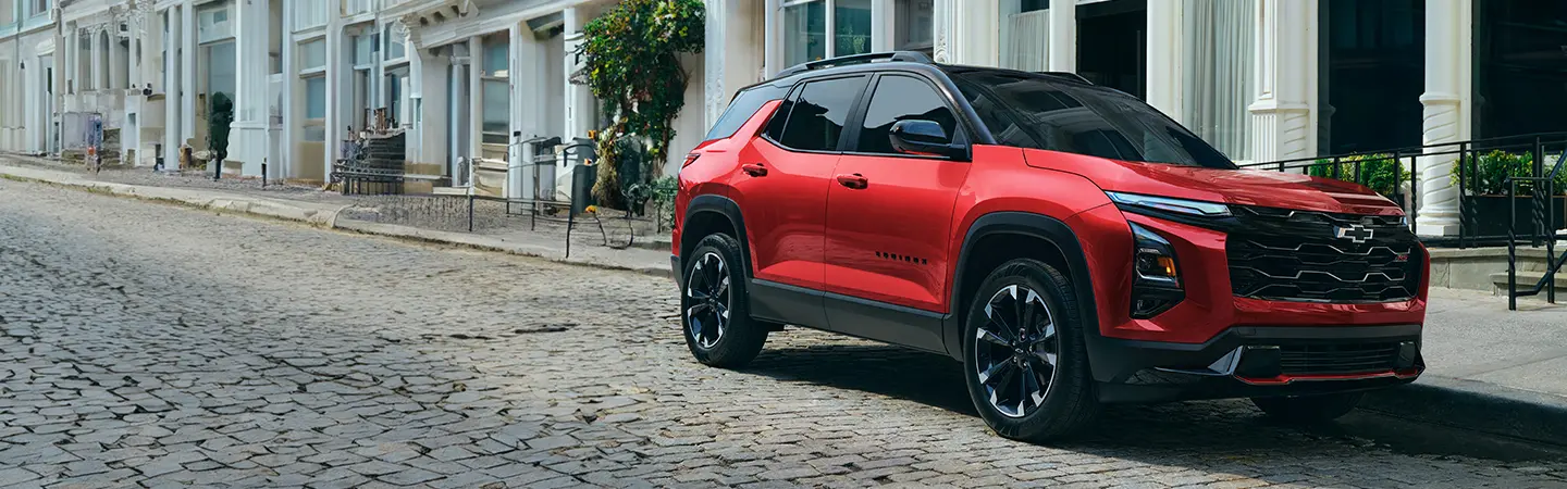 Red 2025 Chevrolet Trax parked on a city street