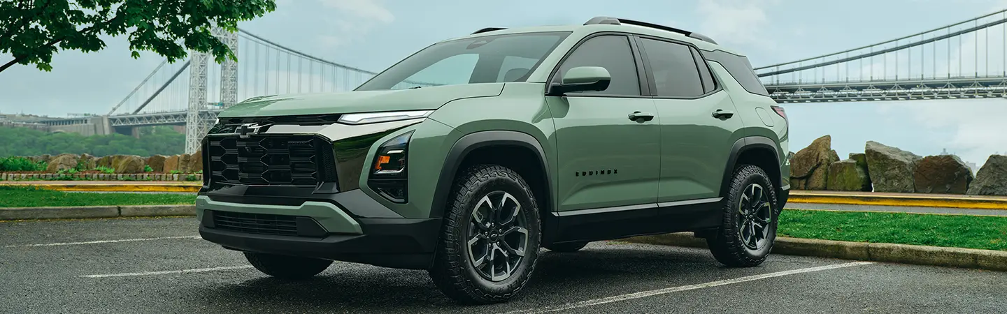 Black 2025 Chevrolet Trax parked next to a lake