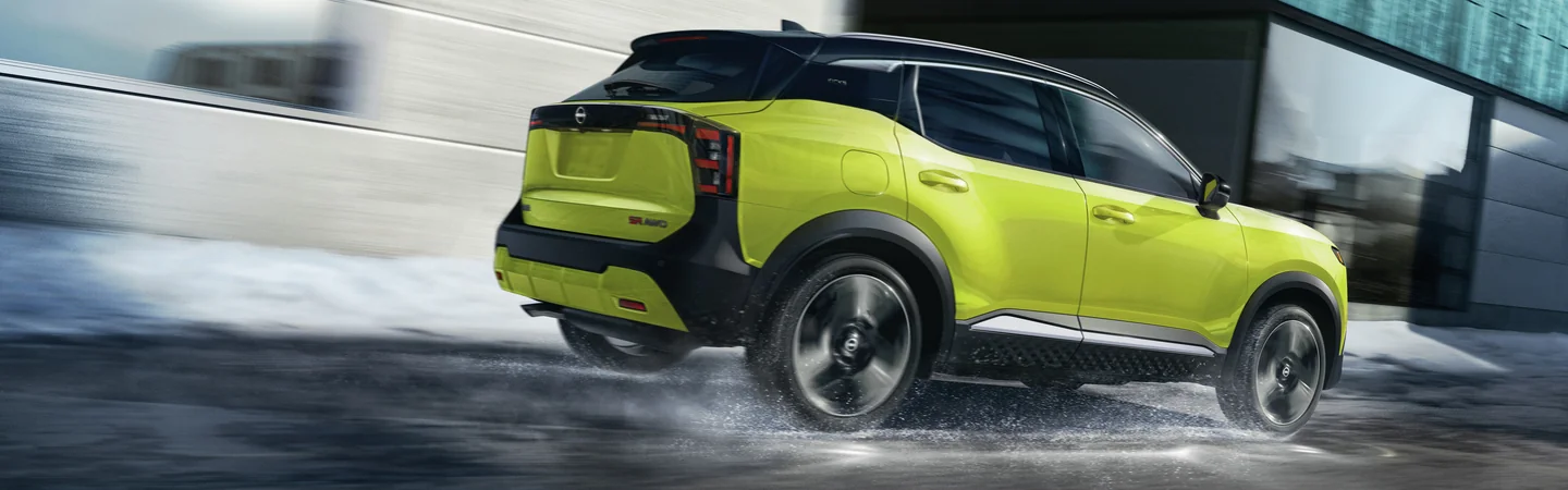 a 2026 Nissan Kicks driving in the rain