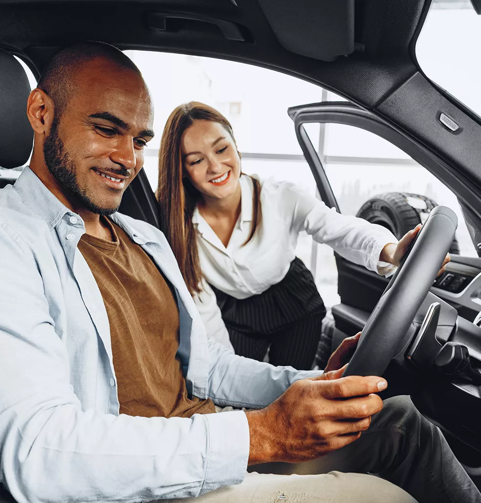 Car sales woman showing a customer a car