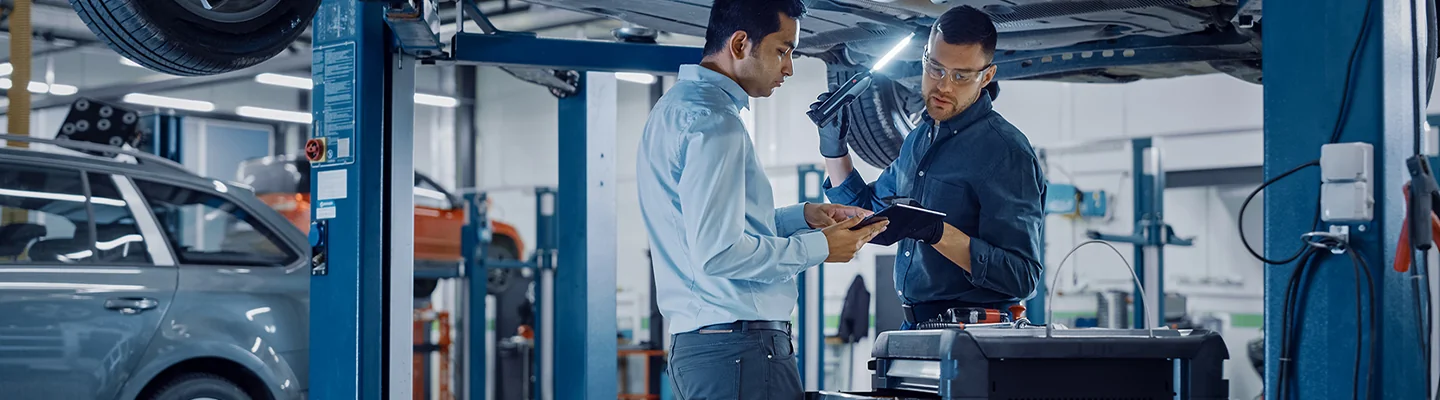 Two service techs working on auto repairs