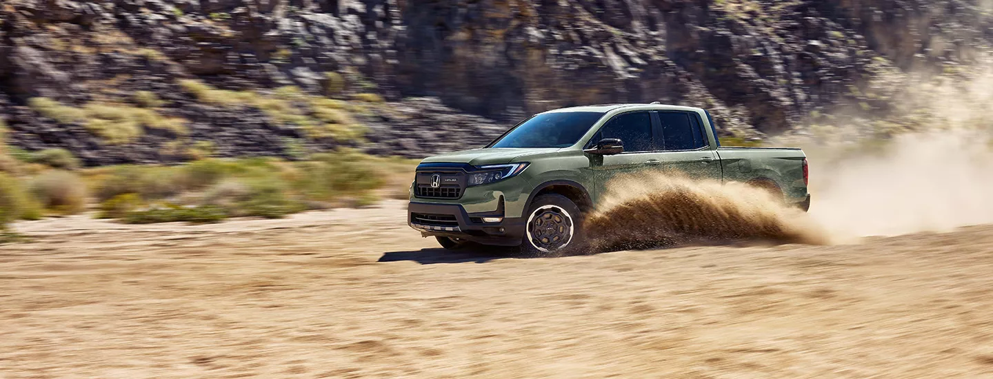 2026 Honda Ridgeline driving through the sand on a beach