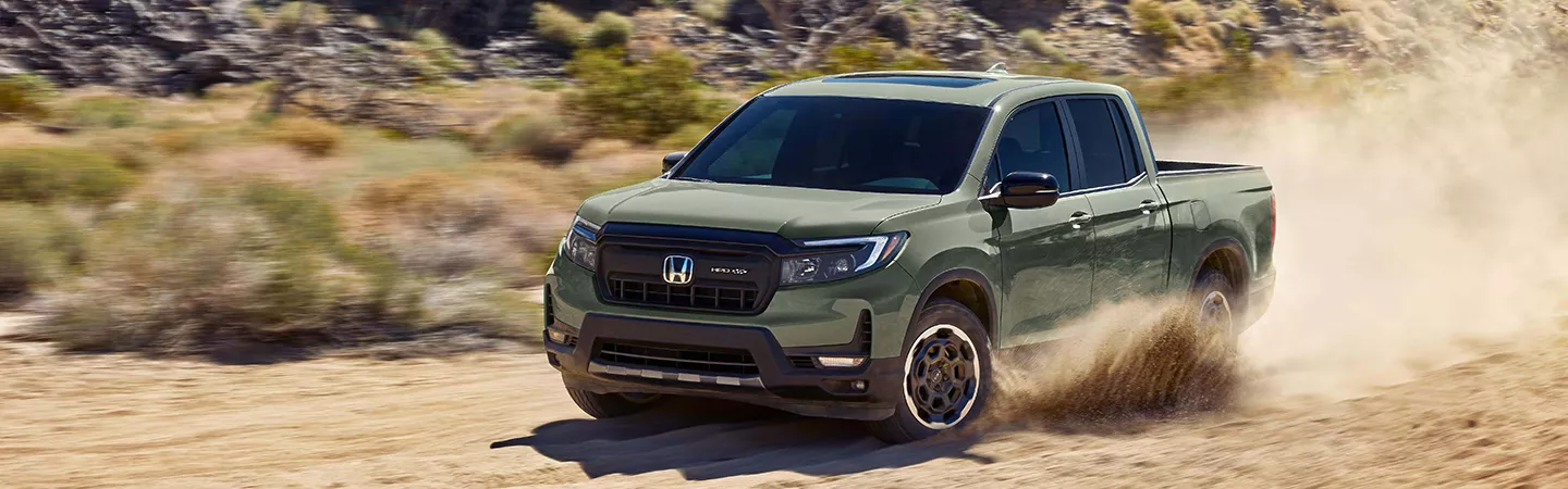 Front view of the 2026 Honda Ridgeline driving on a desert road