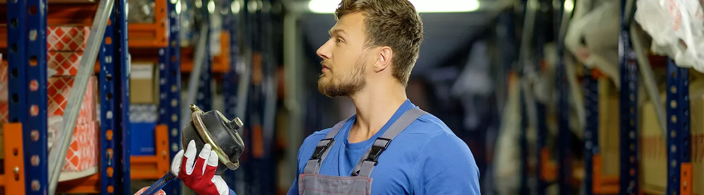 Parts manager looking at a genuine Mopar part