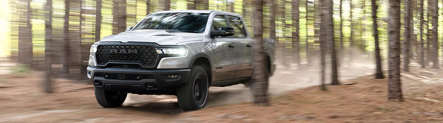 2026 Ram 1500 driving through the woods