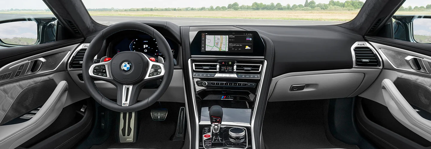 Interior view of the front seat and dashboard of a 2025 BMW M8 Coupe