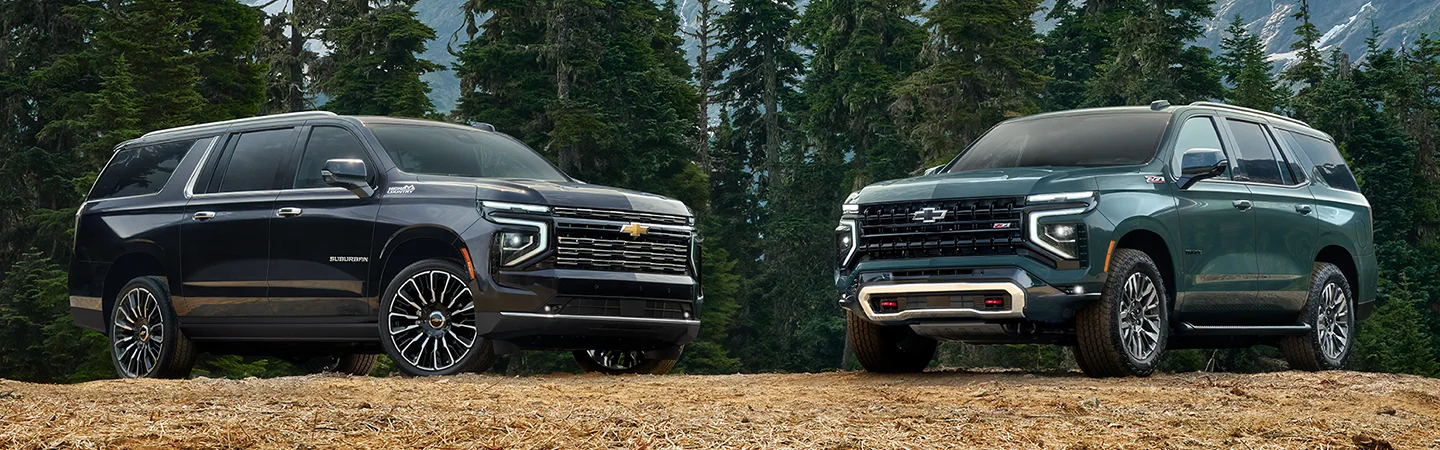 2 2025 Chevrolet Suburban High Country parked near a mountain