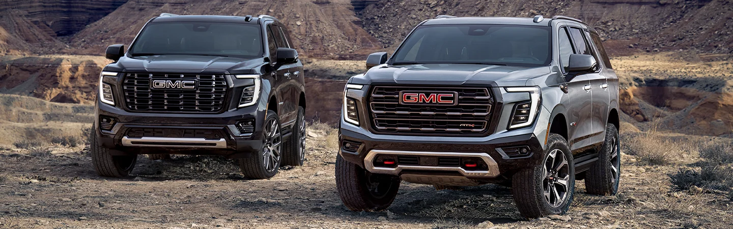 2 2025 GMC Yukon parked in the dirt