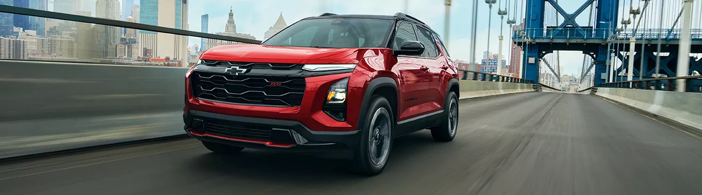 Red 2026 Chevrolet Equinox driving over a bridge