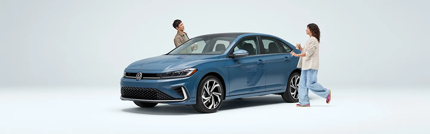 two people near blue VW Jetta