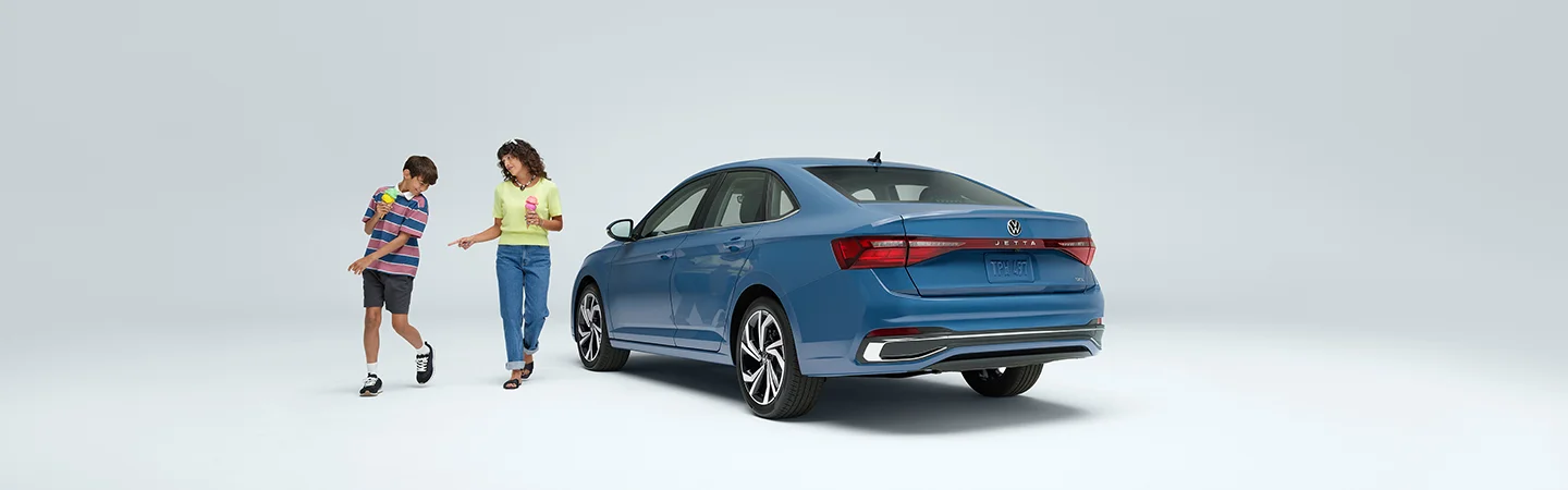 two people near blue VW Jetta