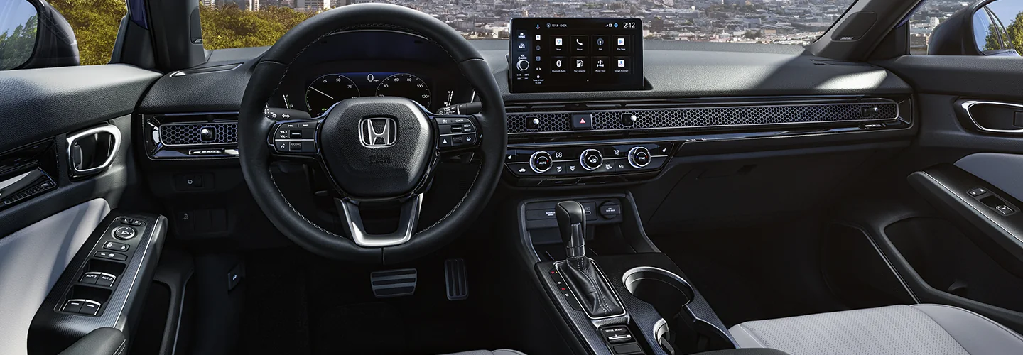 Interior view of the dashboard and tech of a 2026 Honda Civic Hybrid