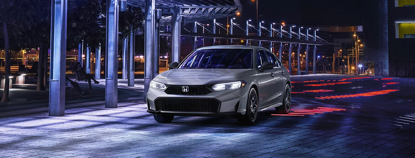 Front view of a gray 2026 Honda Civic Hybrid parked in the city