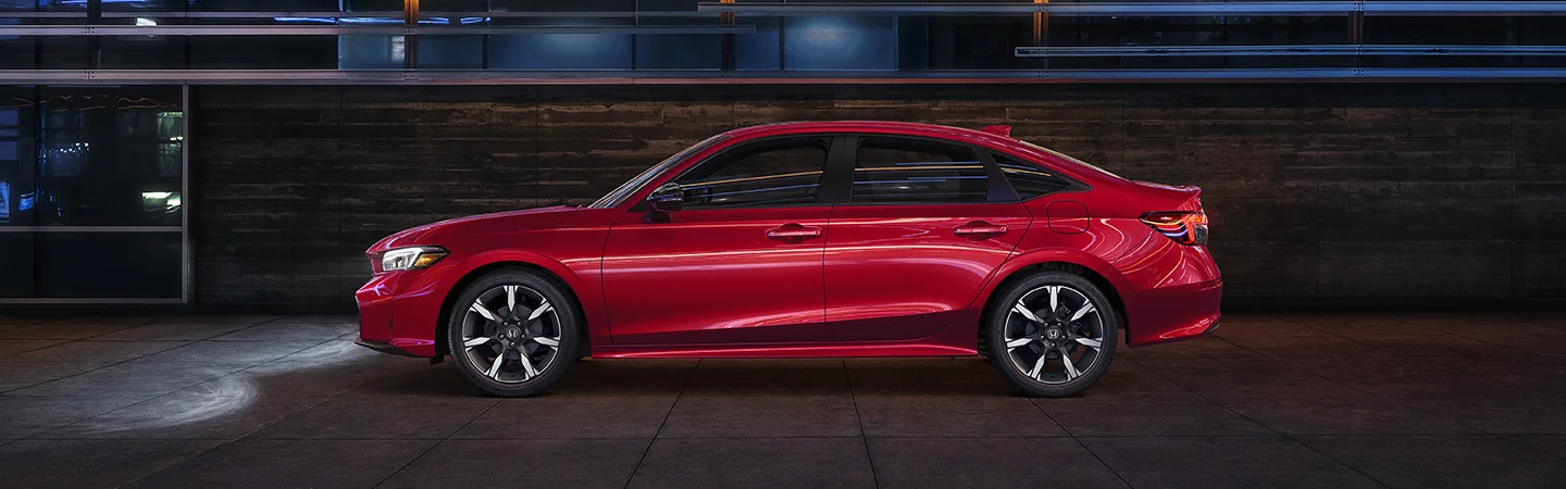 Side view of a parked red 2026 Honda Civic Hybrid
