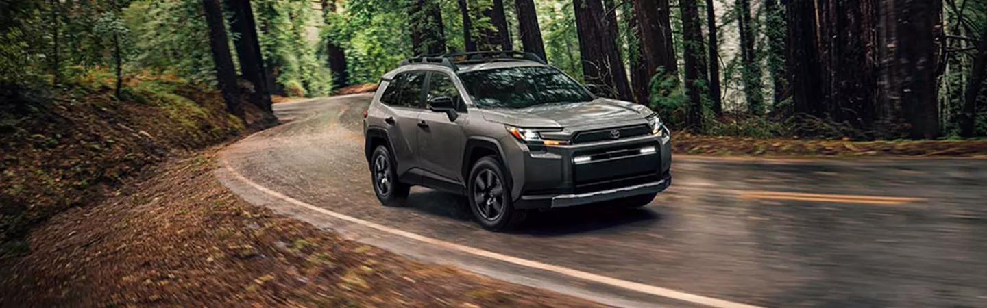 2026 Toyota RAV4 driving through a forest