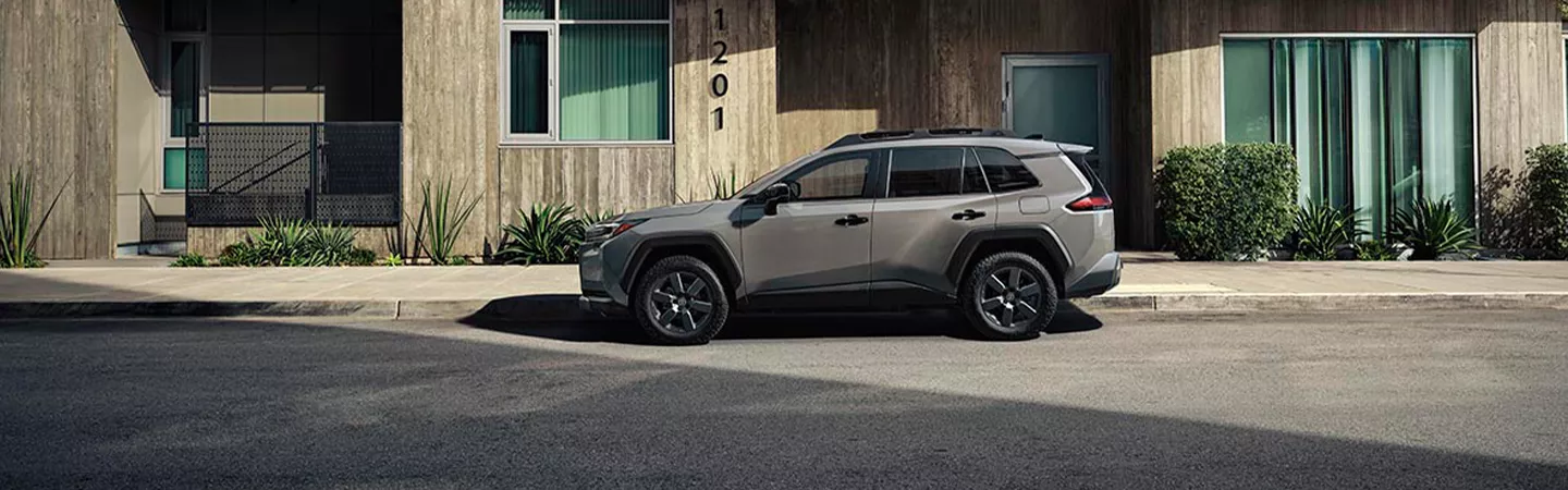 2026 Toyota RAV4 parked in front of a house
