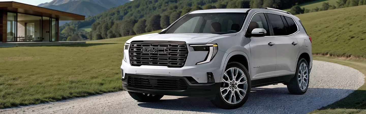 2026 GMC Acadia riding down a driveway
